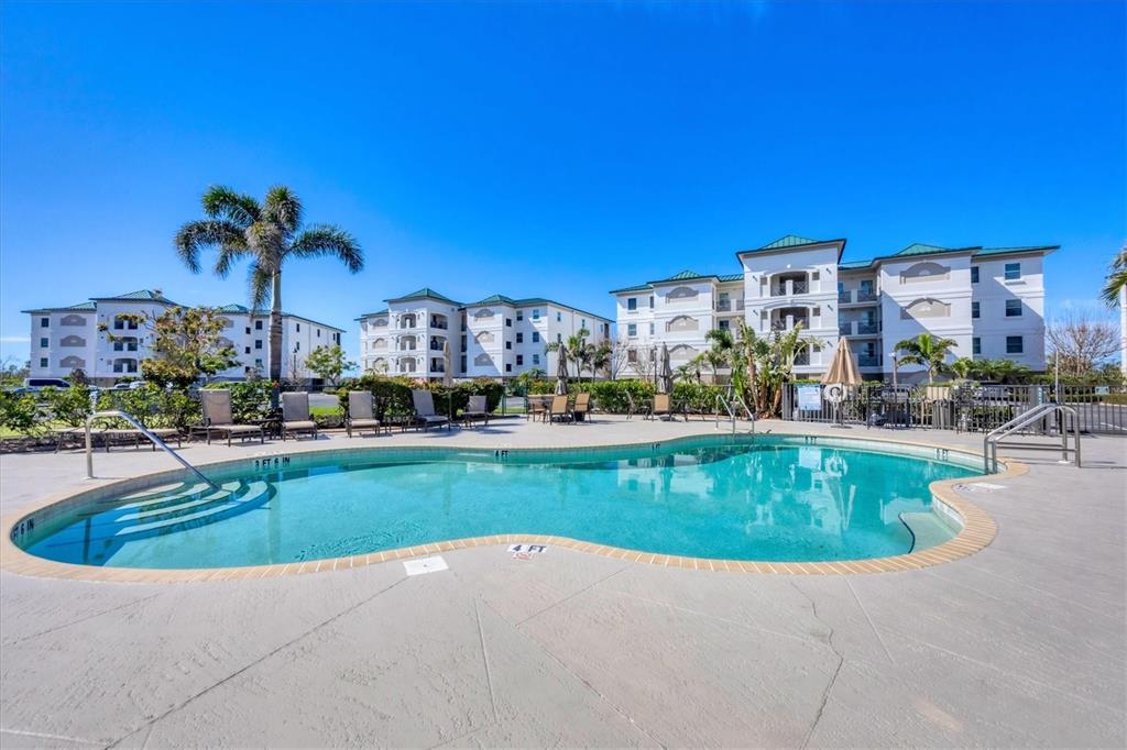 9203 Griggs Road, Unit A204 Englewood, FL 34224 - Photo 34 of 54 a view of a house with a swimming pool
