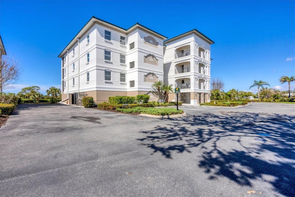 9203 Griggs Road, Unit A204 Englewood, FL 34224 - Photo 4 of 54 a view of a building with a street