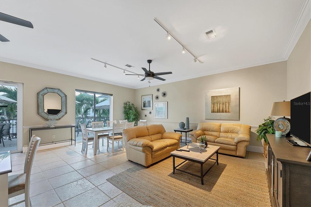 9203 Griggs Road, Unit A204 Englewood, FL 34224 - Photo 51 of 54 a living room with furniture and a flat screen tv