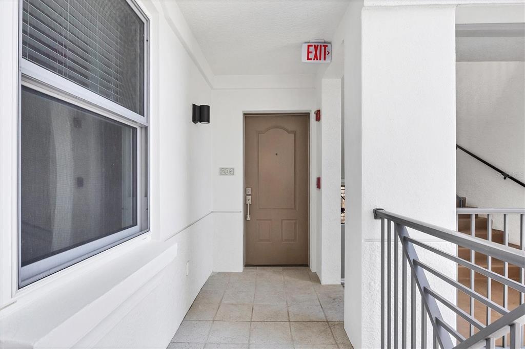 9203 Griggs Road, Unit A204 Englewood, FL 34224 - Photo 8 of 54 a view of a hallway with entryway doors