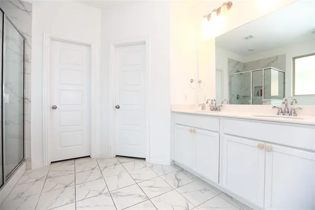a bathroom with a sink vanity and mirror