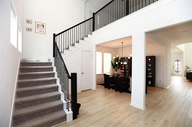 a view of a hallway view with wooden floor and staircase