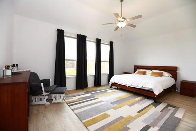 a bedroom with a bed window and a desk