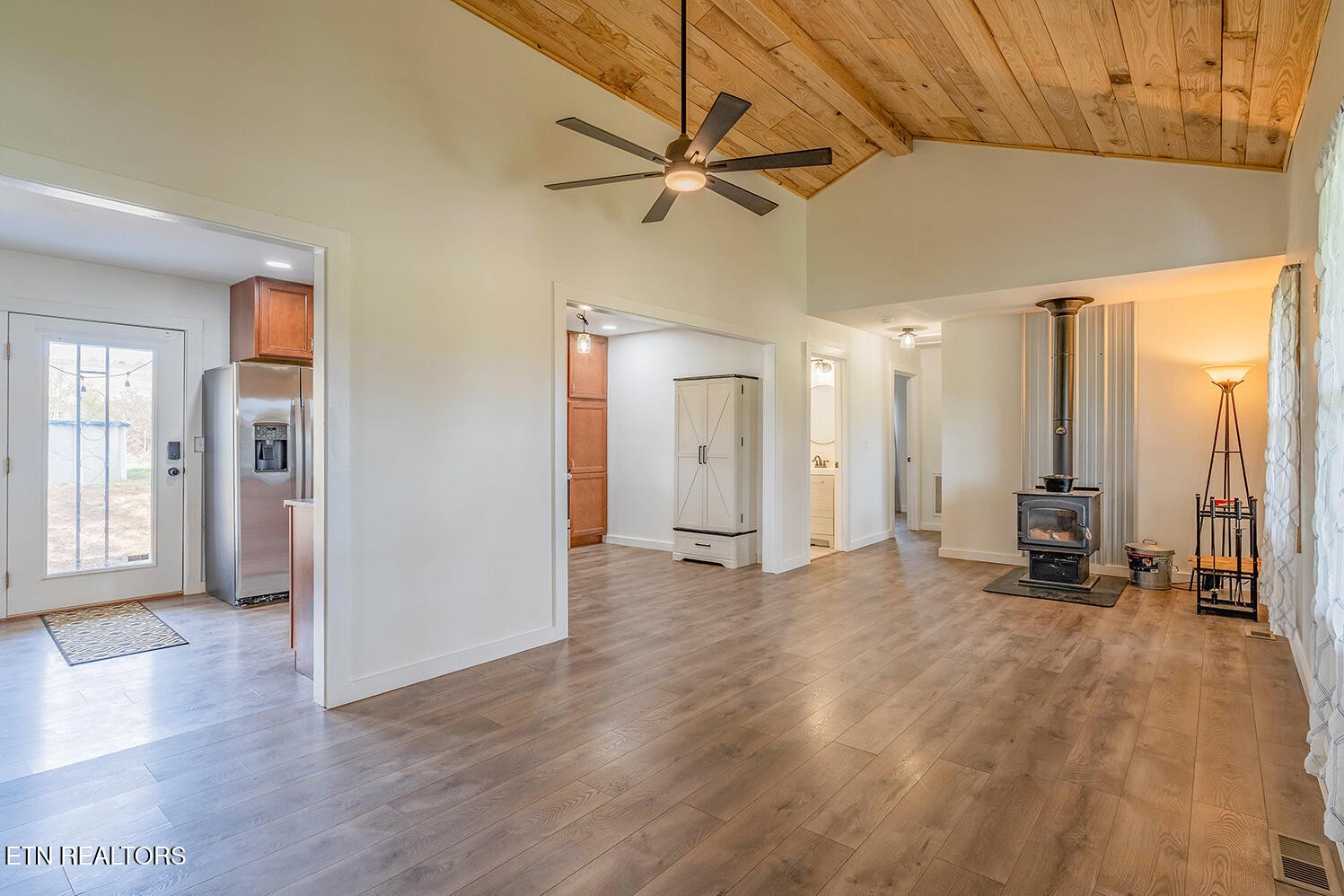 5113 Poplar Springs Road Greeneville, TN 37743 - Photo 4 of 40 a view of a livingroom with a furniture wooden floor and a ceiling fan