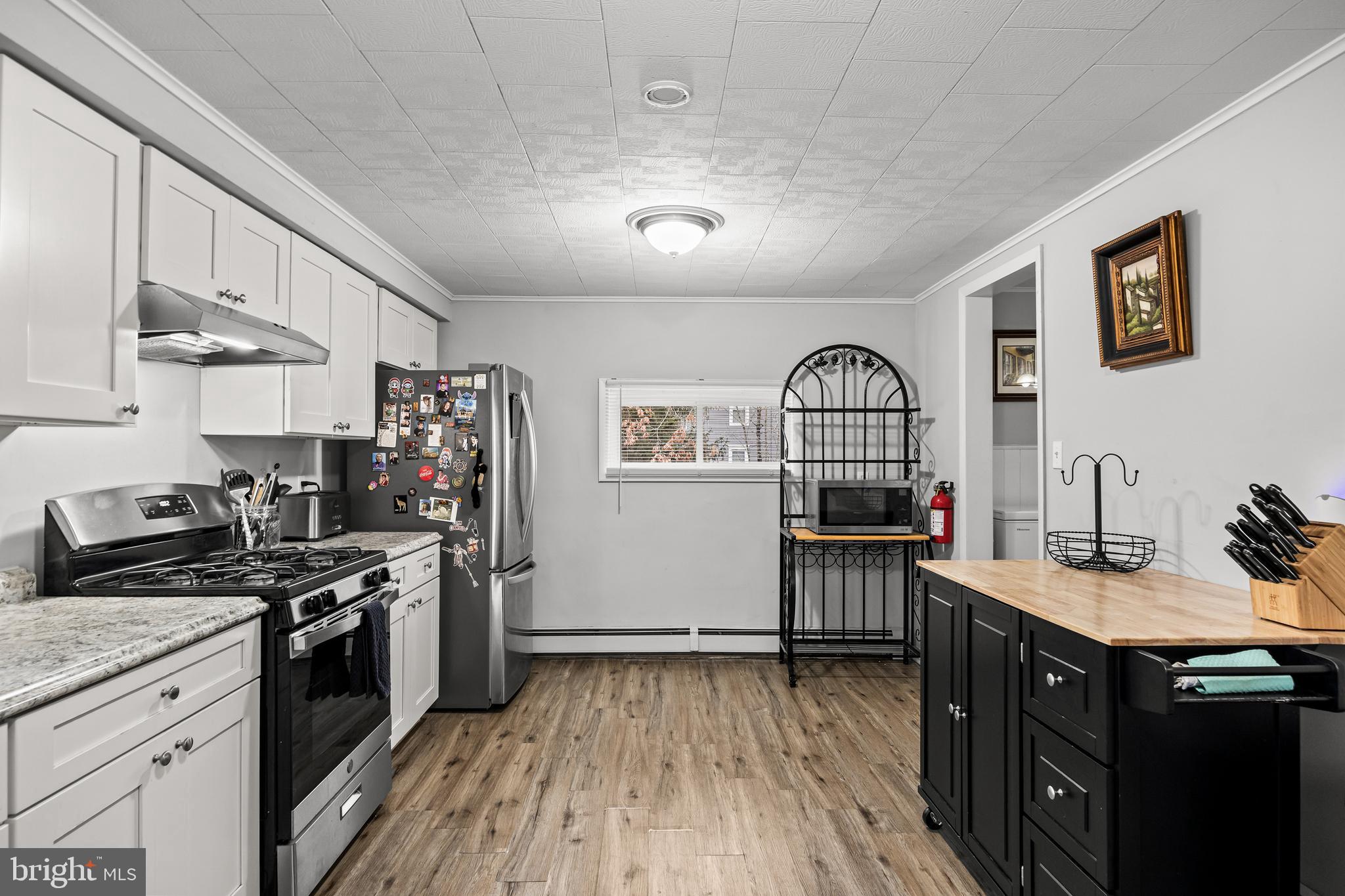 450 South 1st Road Hammonton, NJ 08037 - Photo 5 of 28 a kitchen with stainless steel appliances granite countertop a stove cabinets and wooden floor