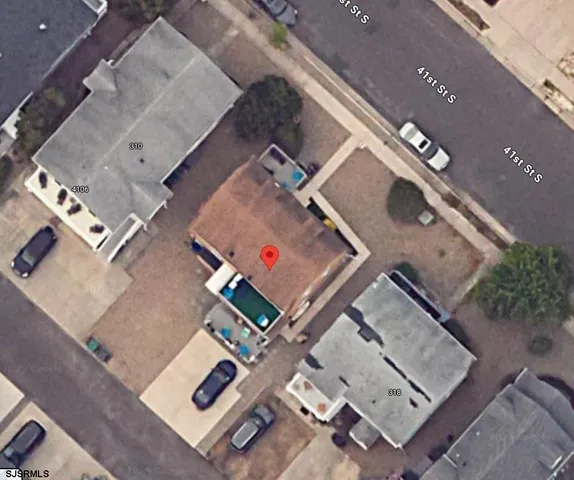 an aerial view of residential house with parking