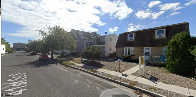 a view of a patio with table and chairs and potted plants