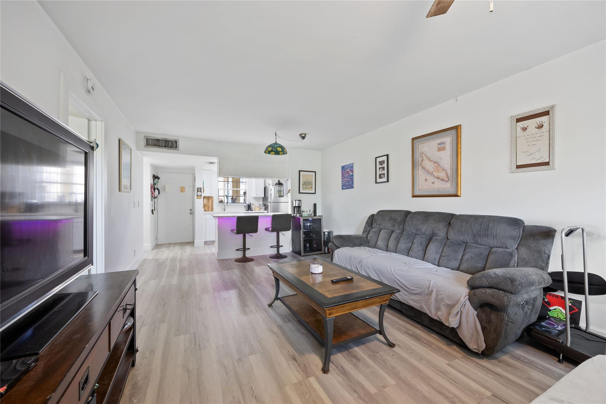 6332 La Costa Drive, Unit B Boca Raton, FL 33433 - Photo 2 of 13 a living room with furniture and a flat screen tv