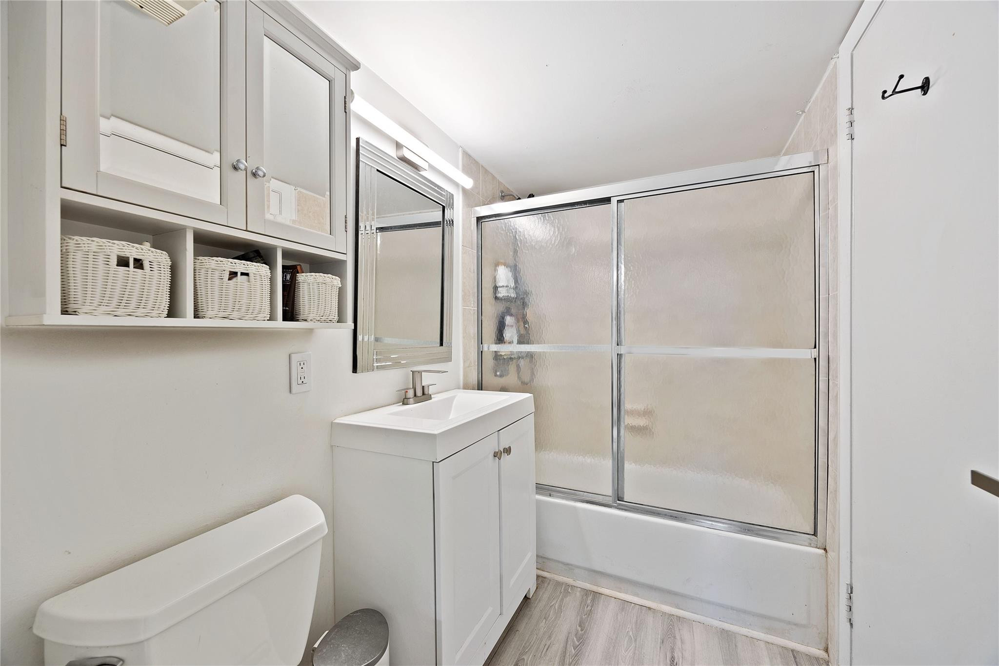 6332 La Costa Drive, Unit B Boca Raton, FL 33433 - Photo 7 of 13 a bathroom with a toilet a sink and a mirror