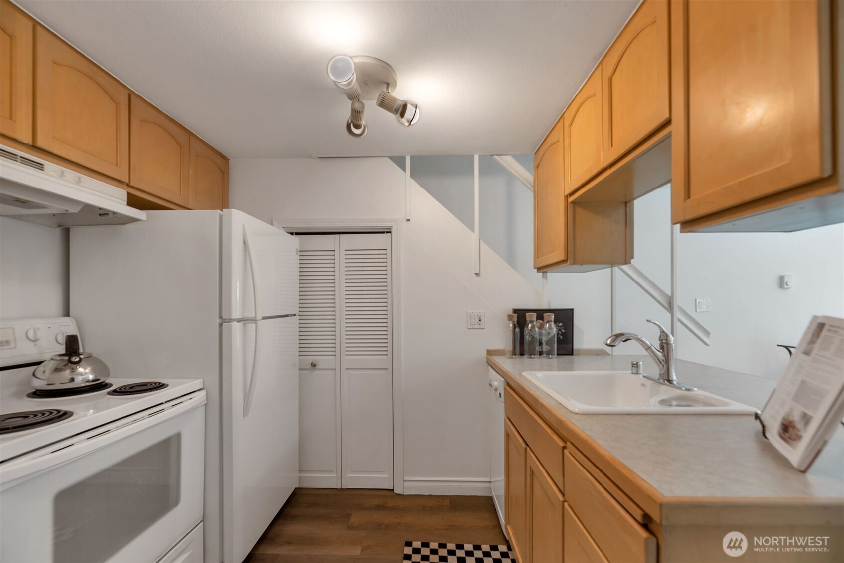 1000 Union Street, Unit 110 Seattle, WA 98101 - Photo 12 of 16 a kitchen with stainless steel appliances granite countertop a sink stove and refrigerator