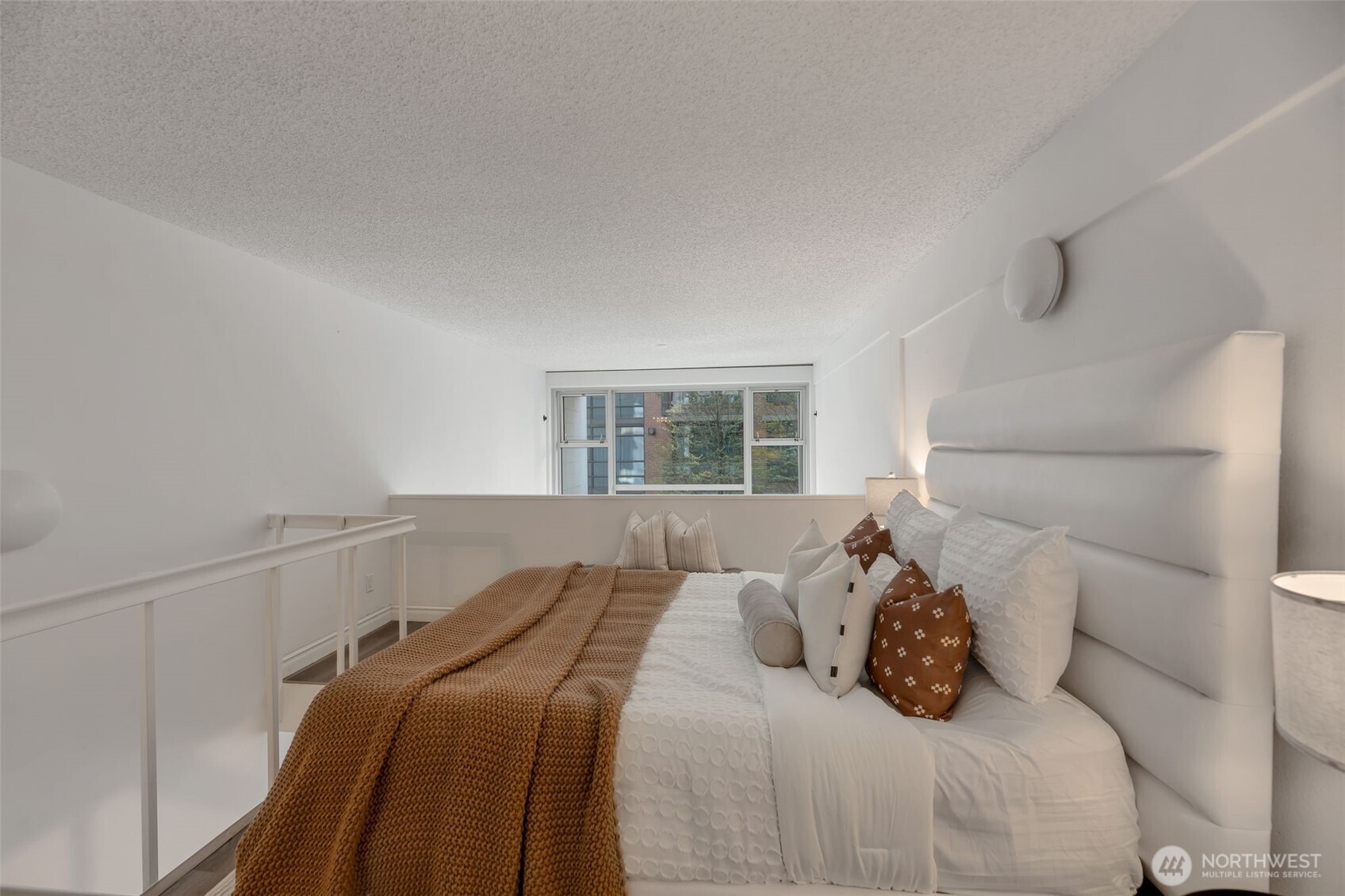1000 Union Street, Unit 110 Seattle, WA 98101 - Photo 14 of 16 a bedroom with a bed and a window with outer view