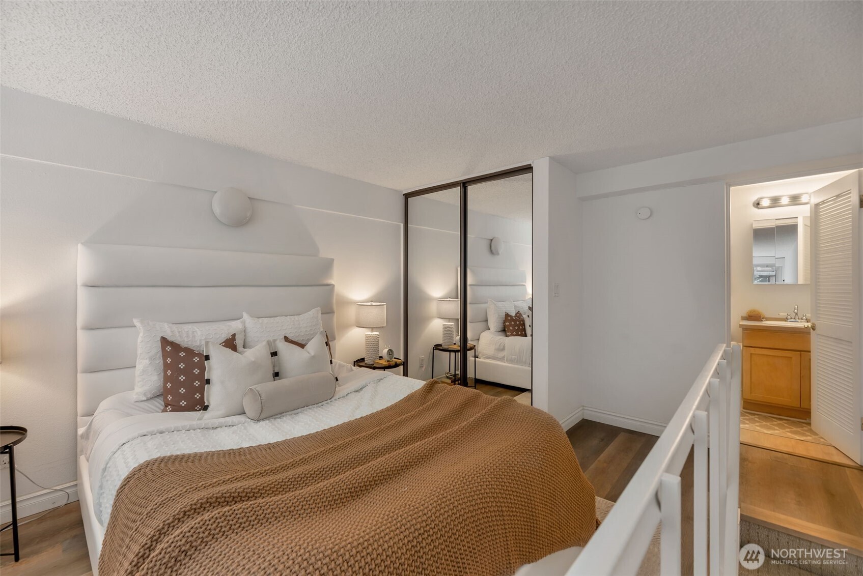 1000 Union Street, Unit 110 Seattle, WA 98101 - Photo 15 of 16 a bedroom with a bed and wooden floor