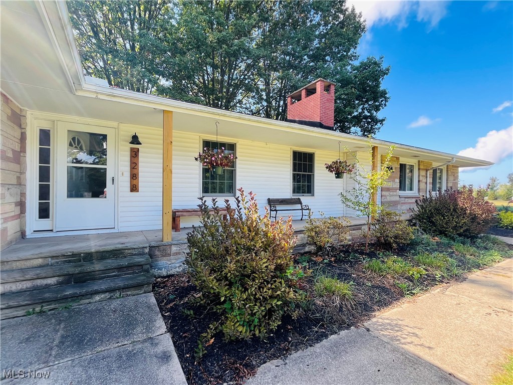 3288 Call Road Perry, OH 44081 - Photo 2 of 5 View of front facade featuring a porch and a chimney