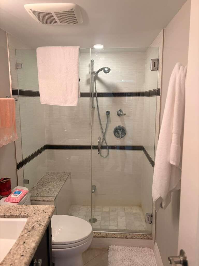 2611 North Riverside Drive, Unit 703 Pompano Beach, FL 33062 - Photo 59 of 81 a bathroom with a granite countertop sink toilet and shower