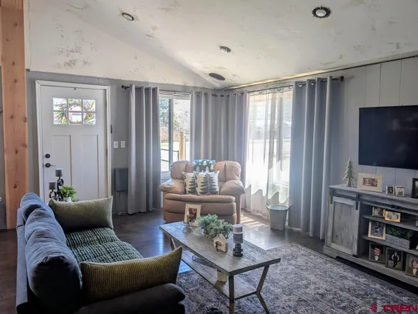 a living room with furniture and a flat screen tv