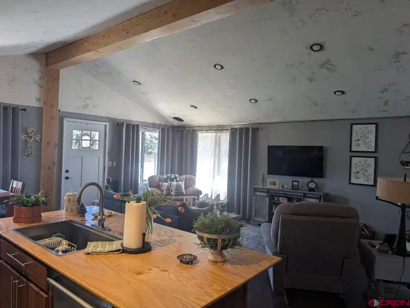 a kitchen with a stove a sink and a refrigerator