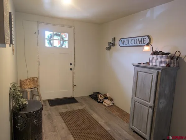 a view of a storage & utility room with closet fridge