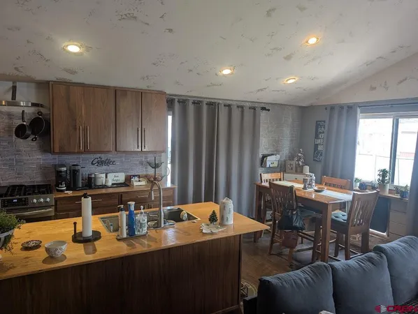 a kitchen with a table chairs stove and cabinets
