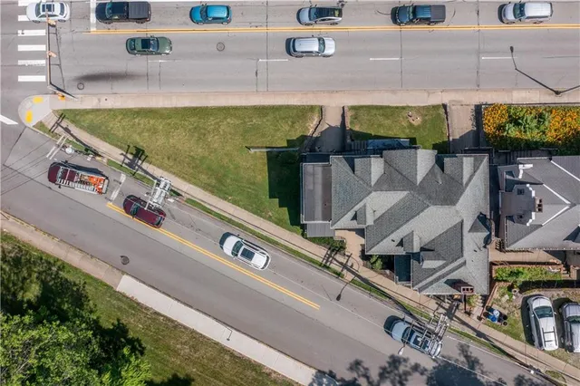 an aerial view of a house with a swimming pool