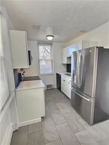 a kitchen with a refrigerator sink and stove