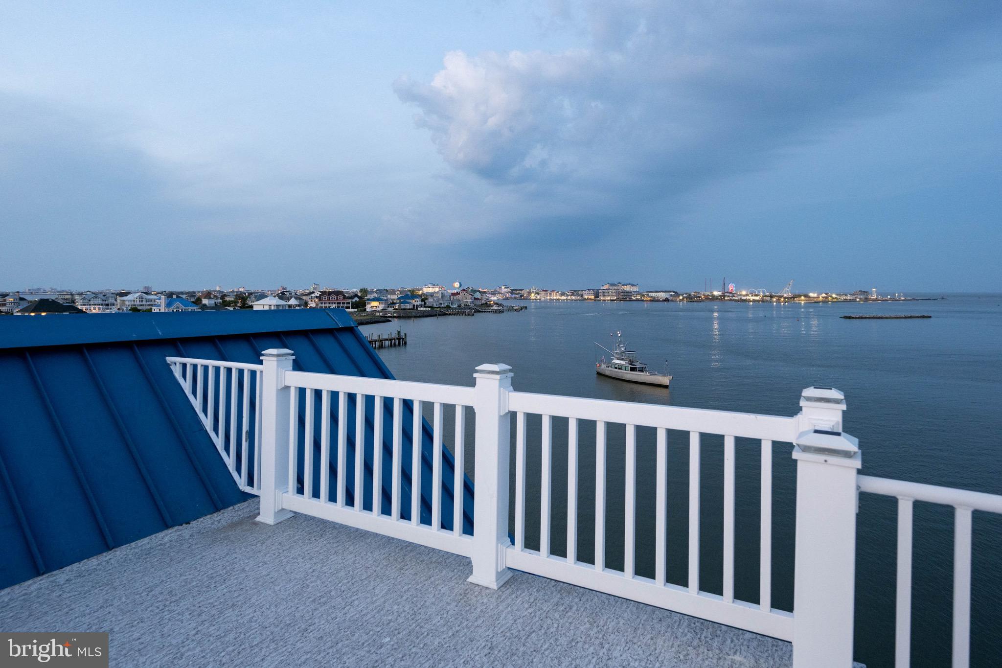 12959 Harbor Road Ocean City, MD 21842 - Photo 47 of 85 a balcony with wooden floor and city view
