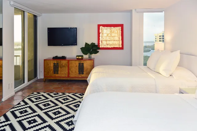 a bedroom with a bed and a flat screen tv