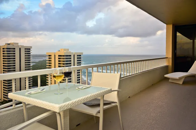 a view of a balcony with table and chairs