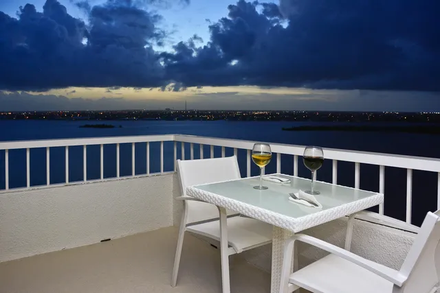 a view of a balcony with table and chairs