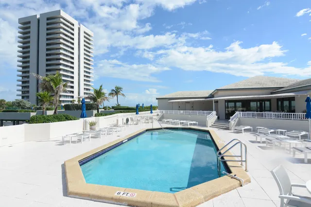 a view of swimming pool with outdoor seating and city view
