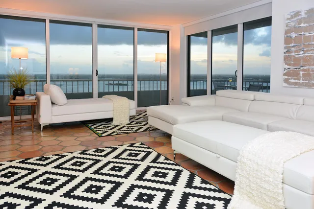 a spacious bedroom with a large bed and a large window