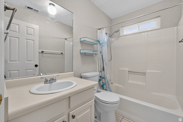 1690 Maplewood Way St. George, UT 84790 - Photo 10 of 17 Full bathroom featuring a round vessel sink with chrome faucet and countertop space, large framed mirror with integrated lighting, ceramic tile flooring, toilet, and an alcove bathtub/shower combination with glass enclosure and chrome fixtures