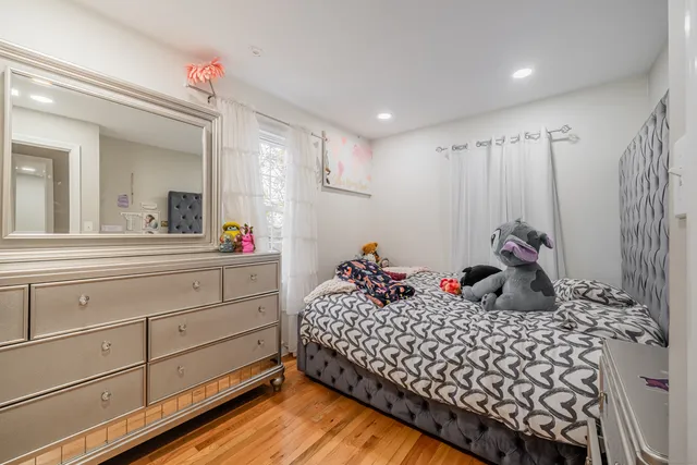 a bedroom with a bed and a dresser