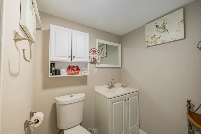 a bathroom with a sink a vanity and toilet