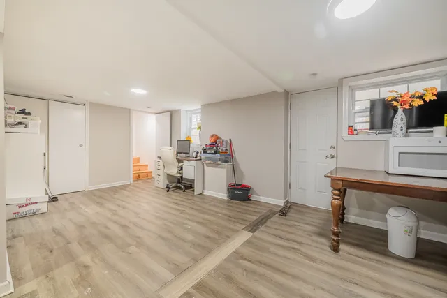 a view of work space with wooden floor and furniture