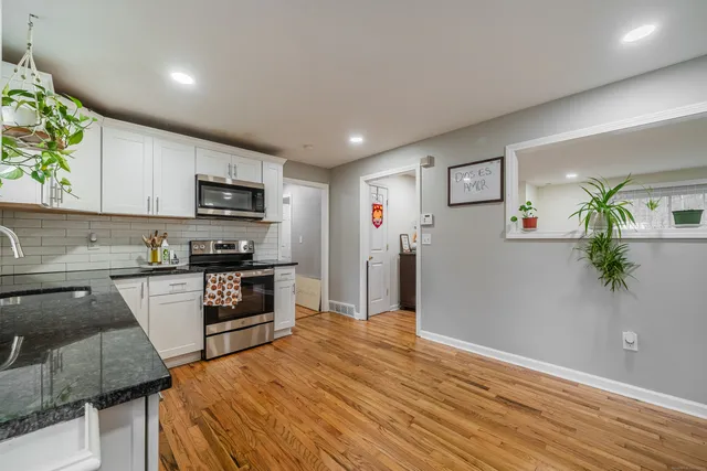 a kitchen with stainless steel appliances a refrigerator sink and microwave