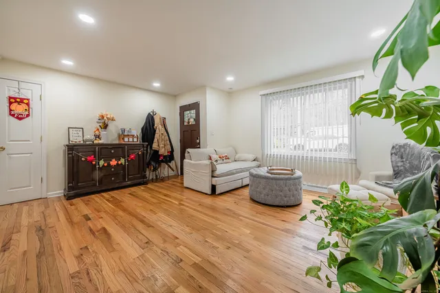 a living room with furniture and a potted plant