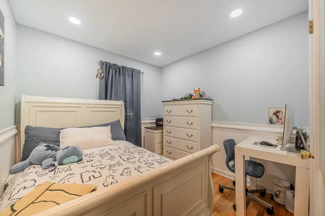 a bedroom with a bed and a desk