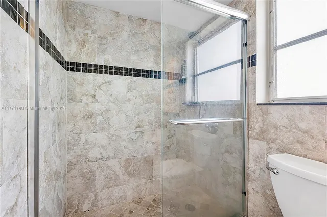 a bathroom with a shower and a toilet