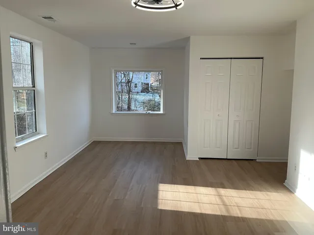 a view of a room with wooden floor and window