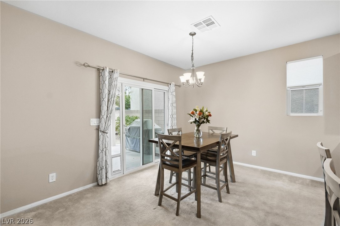 150 Fulgora Street Henderson, NV 89074 - Photo 31 of 92 Dining room featuring light carpet and suspended lighting