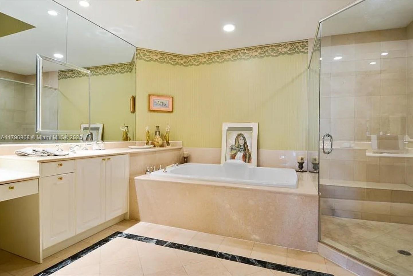 20165 Northeast 39th Place, Unit 403 Aventura, FL 33180 - Photo 13 of 40 a bathroom with a sink mirror and a bath tub