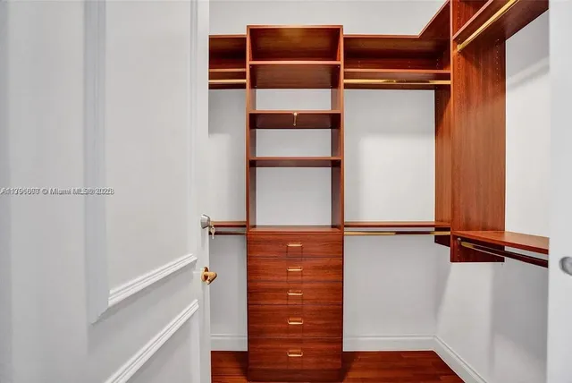 a kitchen with stainless steel appliances granite countertop a sink a stove cabinets and a dining table