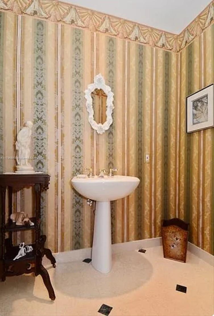 20165 Northeast 39th Place, Unit 403 Aventura, FL 33180 - Photo 22 of 40 a bathroom with a sink a mirror and a shower curtain