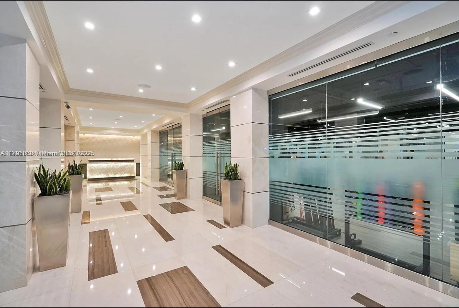 20165 Northeast 39th Place, Unit 403 Aventura, FL 33180 - Photo 25 of 40 a living room with furniture