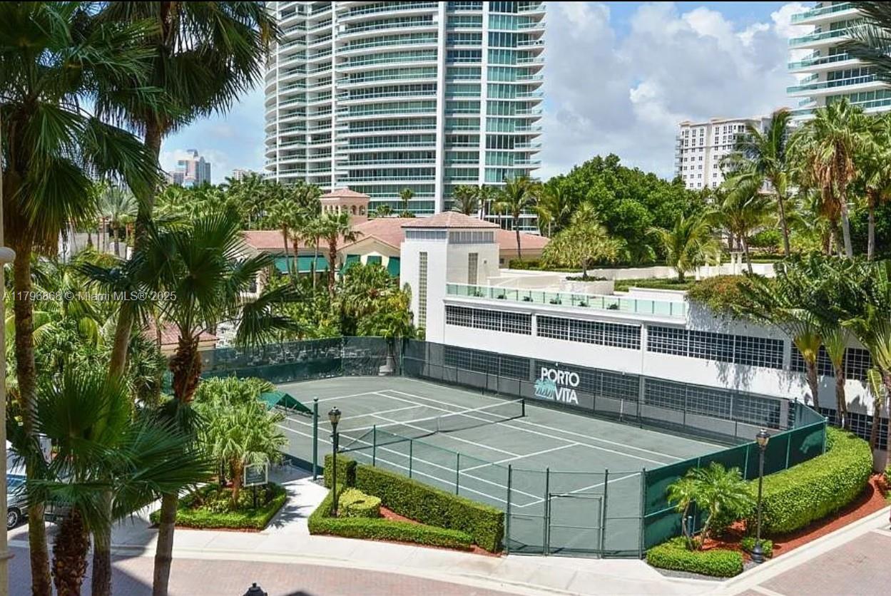 20165 Northeast 39th Place, Unit 403 Aventura, FL 33180 - Photo 27 of 40 a view of a white building with a garden and plants