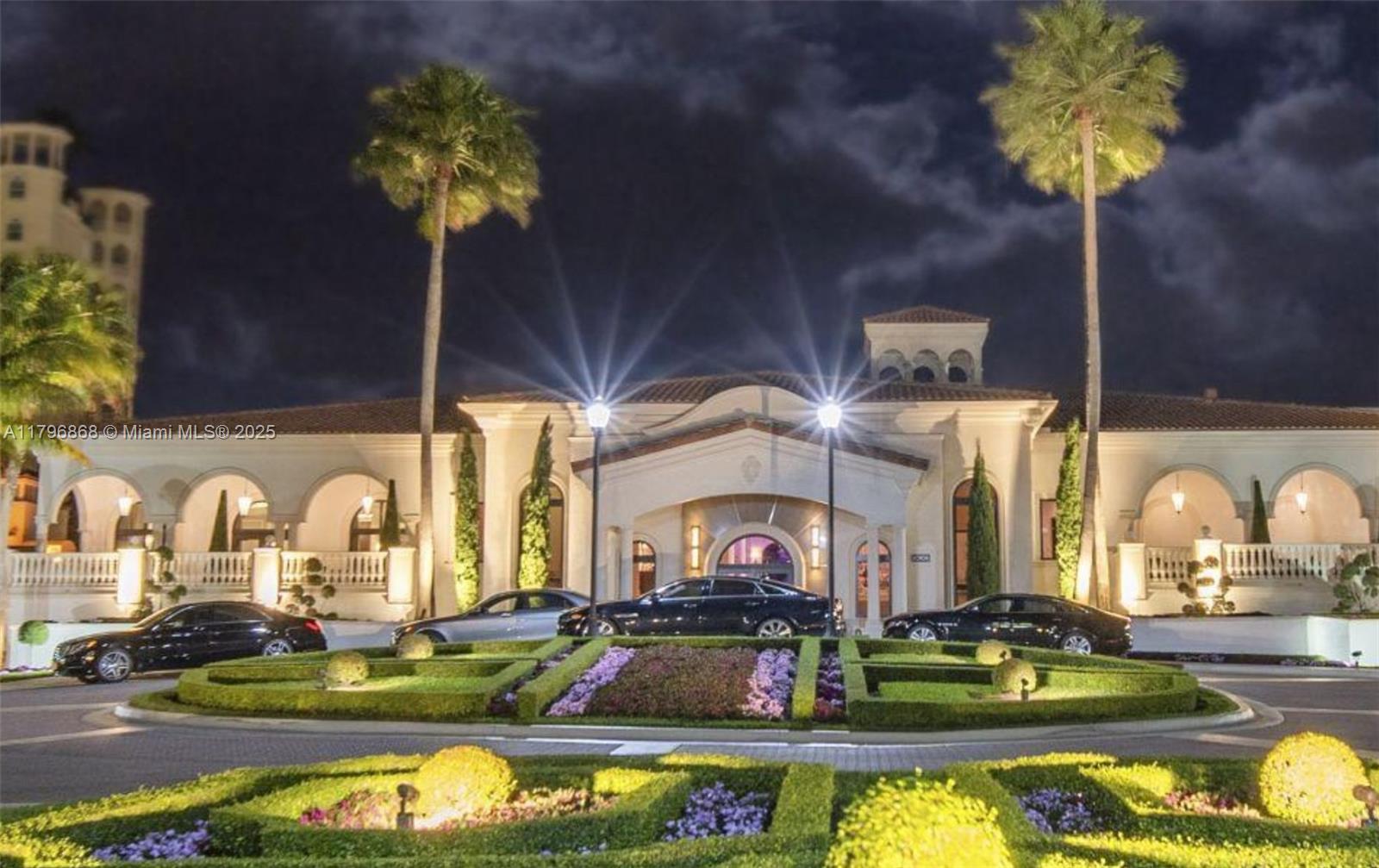 20165 Northeast 39th Place, Unit 403 Aventura, FL 33180 - Photo 29 of 40 a room with lots of white furniture and a chandelier