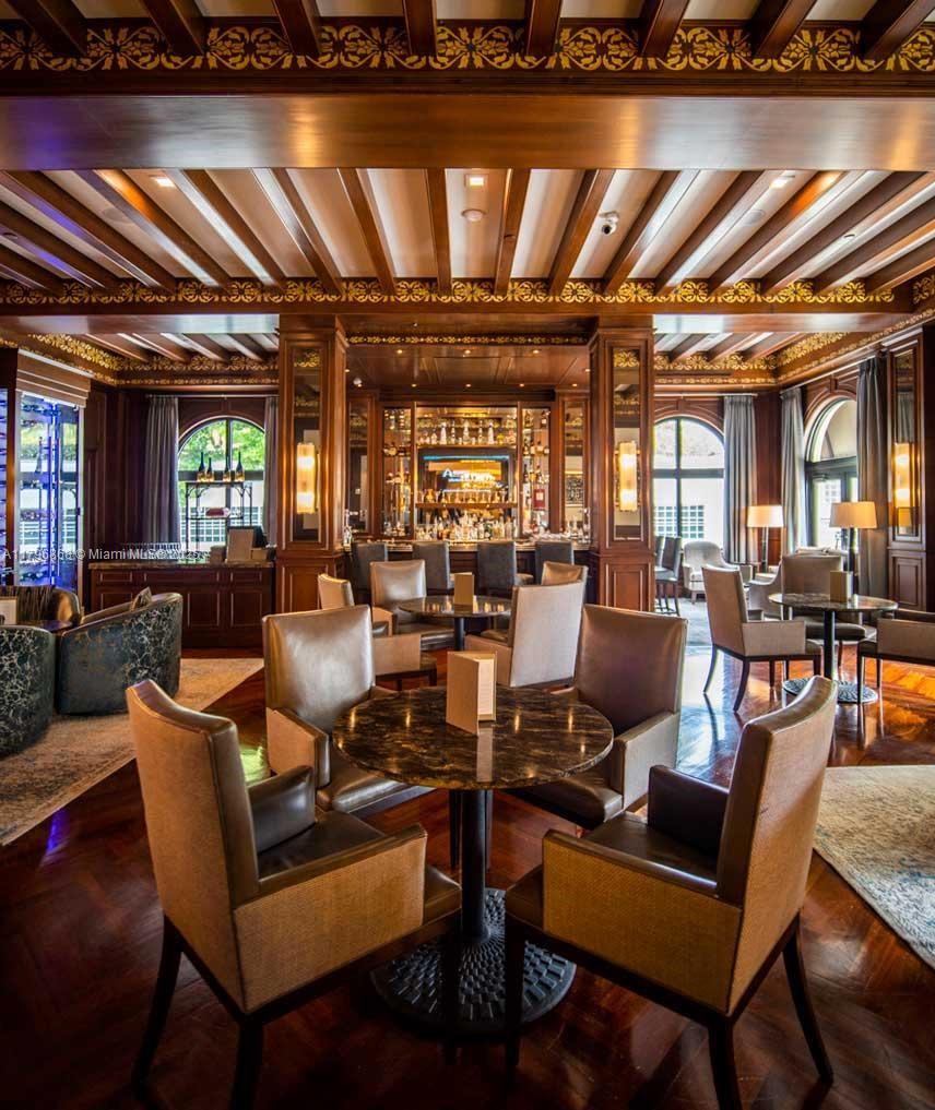 20165 Northeast 39th Place, Unit 403 Aventura, FL 33180 - Photo 33 of 40 a living room with lots of furniture and a table