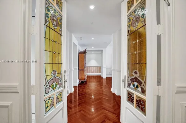 a view of an entryway with wooden floor and door