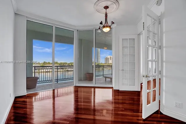 a living room with wooden floor and floor to ceiling window