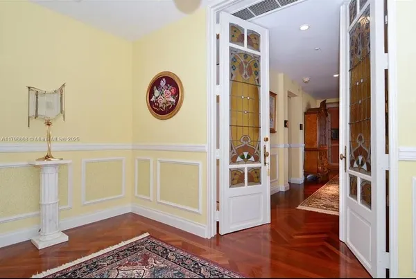 a view of a room with wooden floor